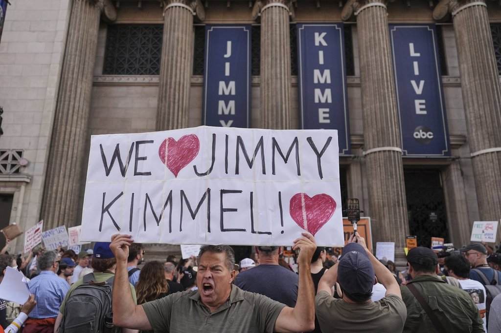 Oscar Villanueva holds a sign outside El Capitan Entertainment Centre, where the late-night show "Jimmy Kimmel Live!" is staged, Thursday, Sept. 18, 2025, in Los Angeles.