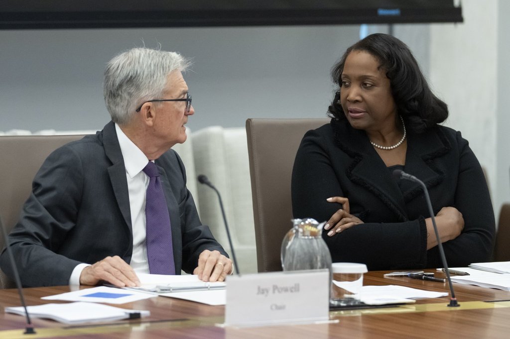 FILE - Federal Reserve Chairman Jerome Powell, left, talks with Board of Governors member Lisa Cook, right, during an open meeting of the Board of Governors at the Federal Reserve, June 25, 2025, in Washington.