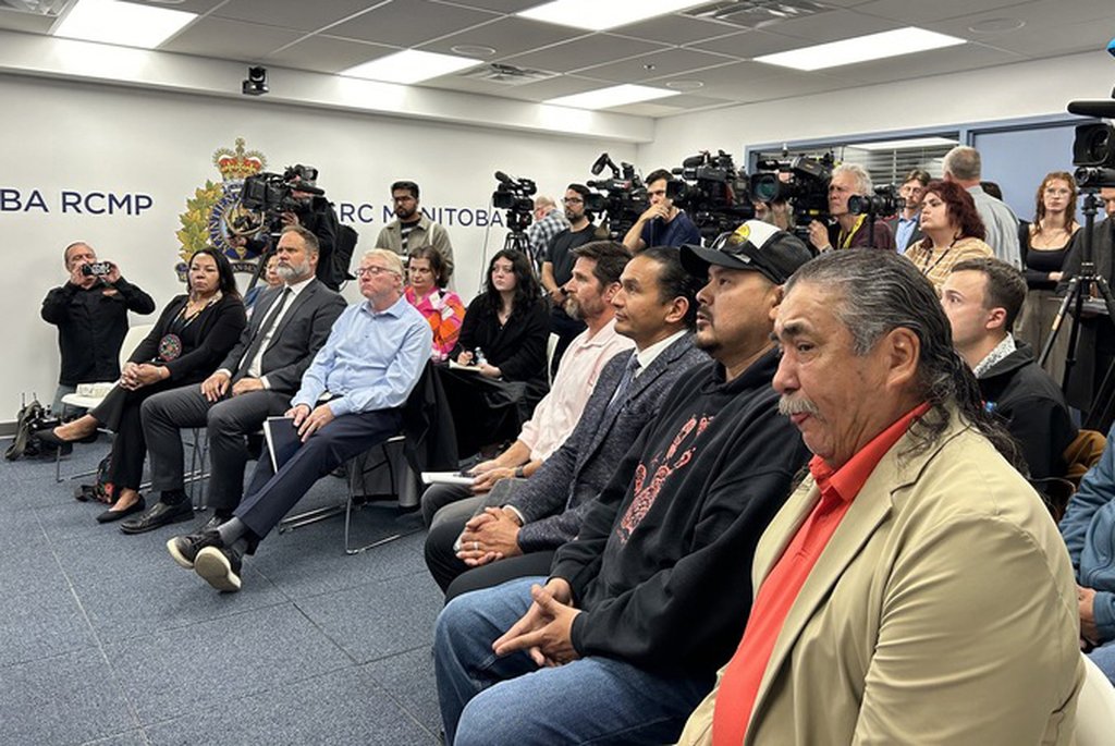 Hollow Water First Nation Chief Larry Barker, front right, and Manitoba Premier Wab Kinew, third right, attend a news conference at the RCMP regional headquarters in Winnipeg on Thursday Sept. 4, 2025. THE CANADIAN PRESS/Brittany Hobson.