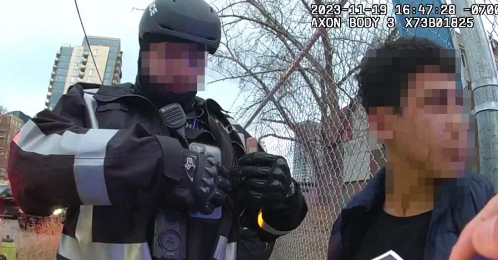 In this photo supplied by ASIRT, a Calgary Police Service officer is shown with a boy who had just been arrested near a protest on November 19, 2023. The boy was later diagnosed with a concussion and found to have scratches on his face. ASIRT's report found the actions of several officers took were "proportionate, necessary and reasonable.".