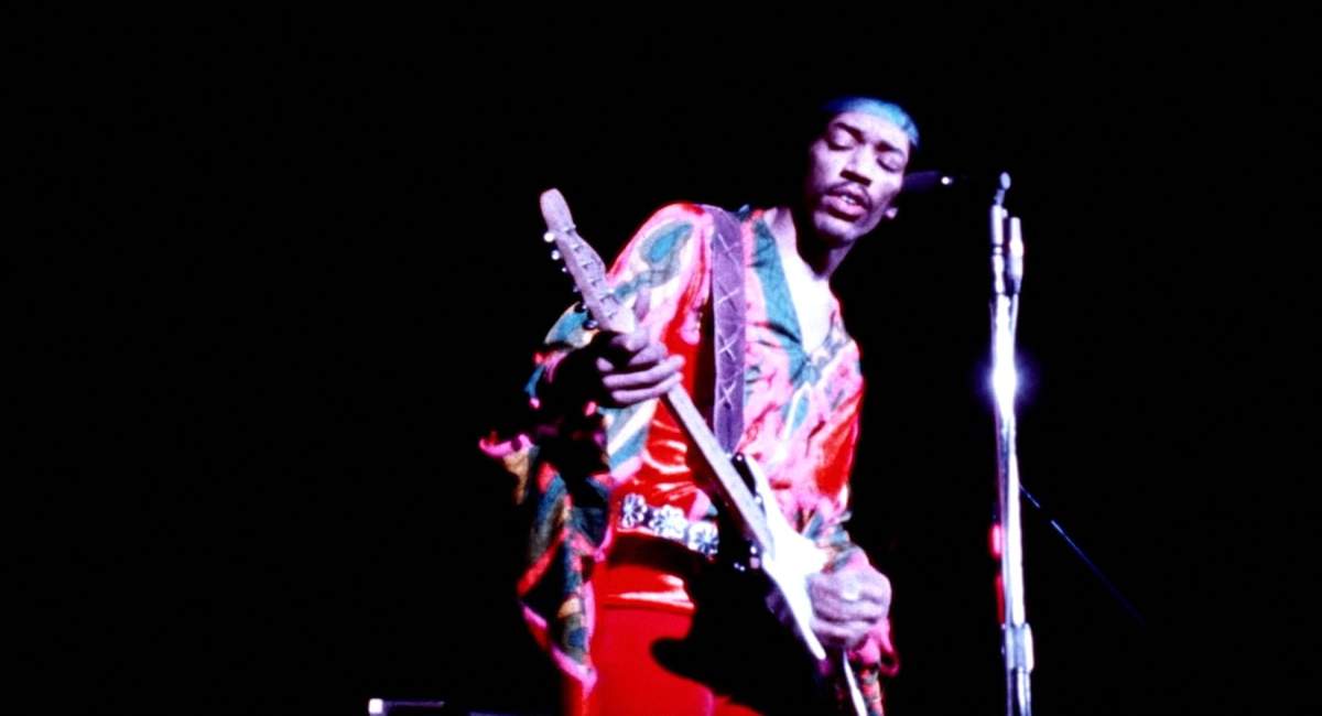 Jimi Hendrix performs on stage