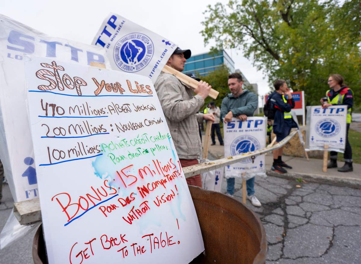 Canada Post workers picket outside a distribution centre as part of a strike action in Montreal on Friday, Sept. 26, 2025.