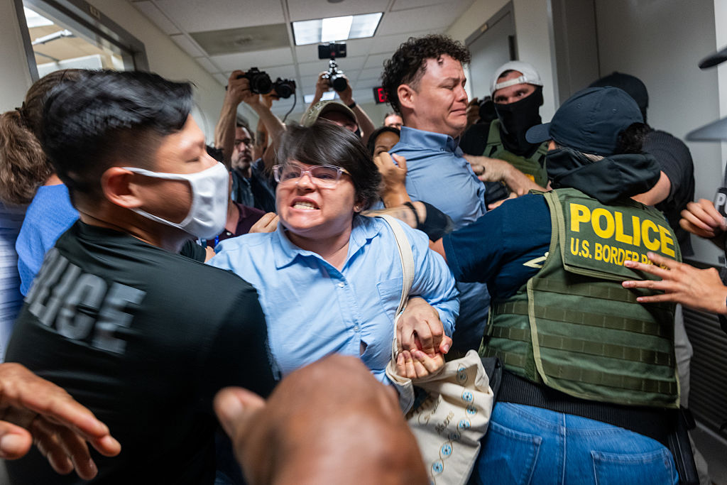 A Paraguayan woman whose relative was detained by Federal agents, scuffles with officers in the halls of immigration court at the Jacob K. Javitz Federal Building on July 16, 2025, in New York City.