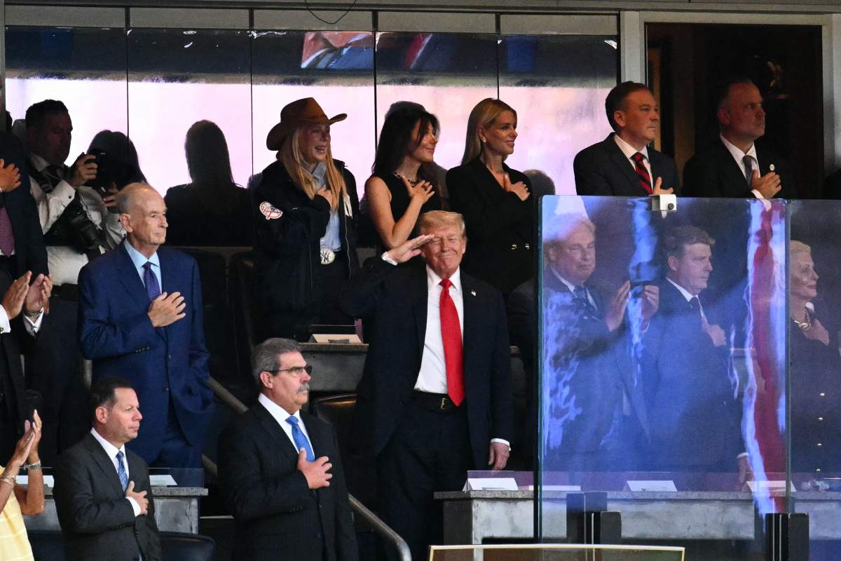 US President Donald Trump salutes during the national anthem as he attends the Yankees baseball game against the Detroit Tigers at Yankee Stadium in the Bronx, New York on September 11, 2025.