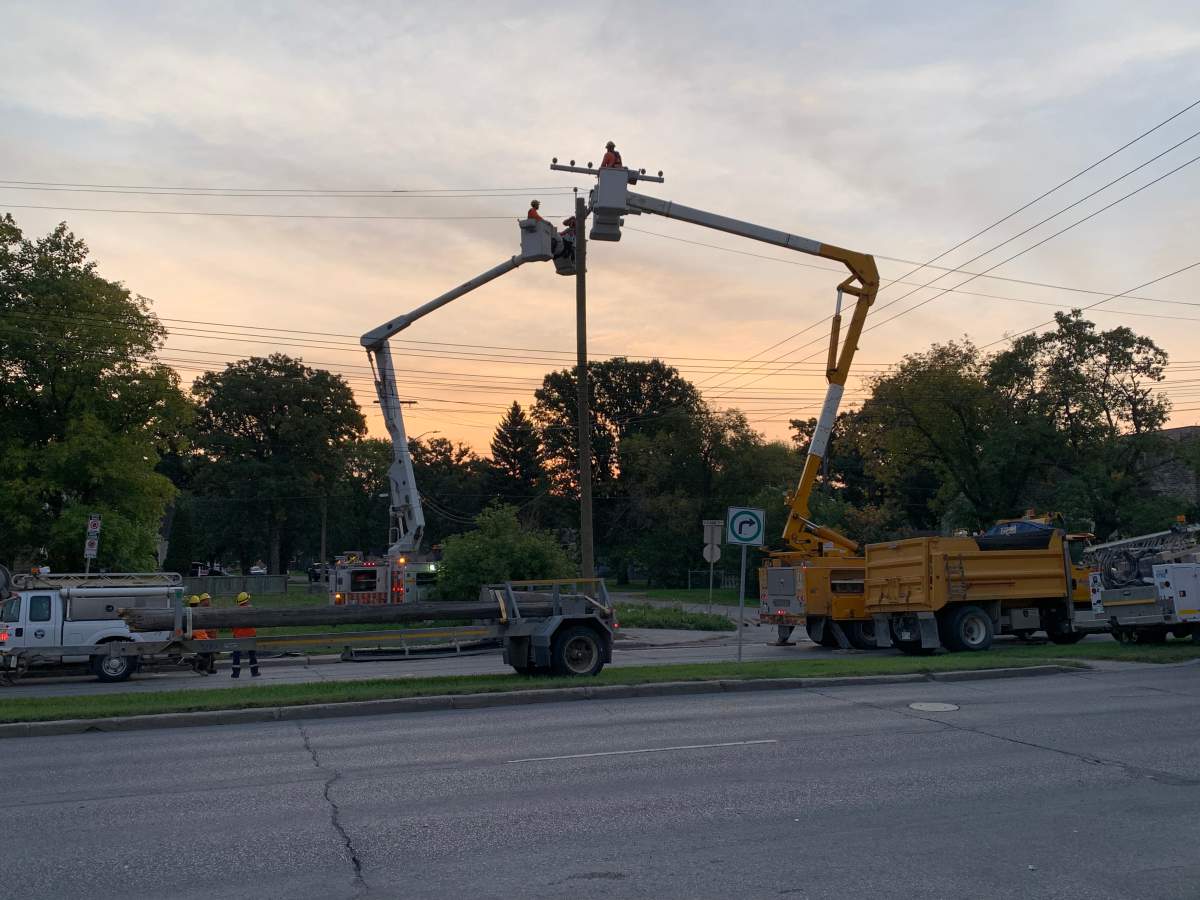 Manitoba Hydro crews work on a damaged hydro pole in Winnipeg Thursday morning.