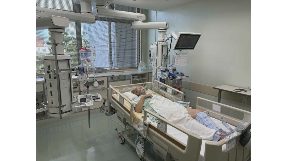 A photo of Dione Amundson as she lays in a hospital be in Japan after suffering a perforated intestine.