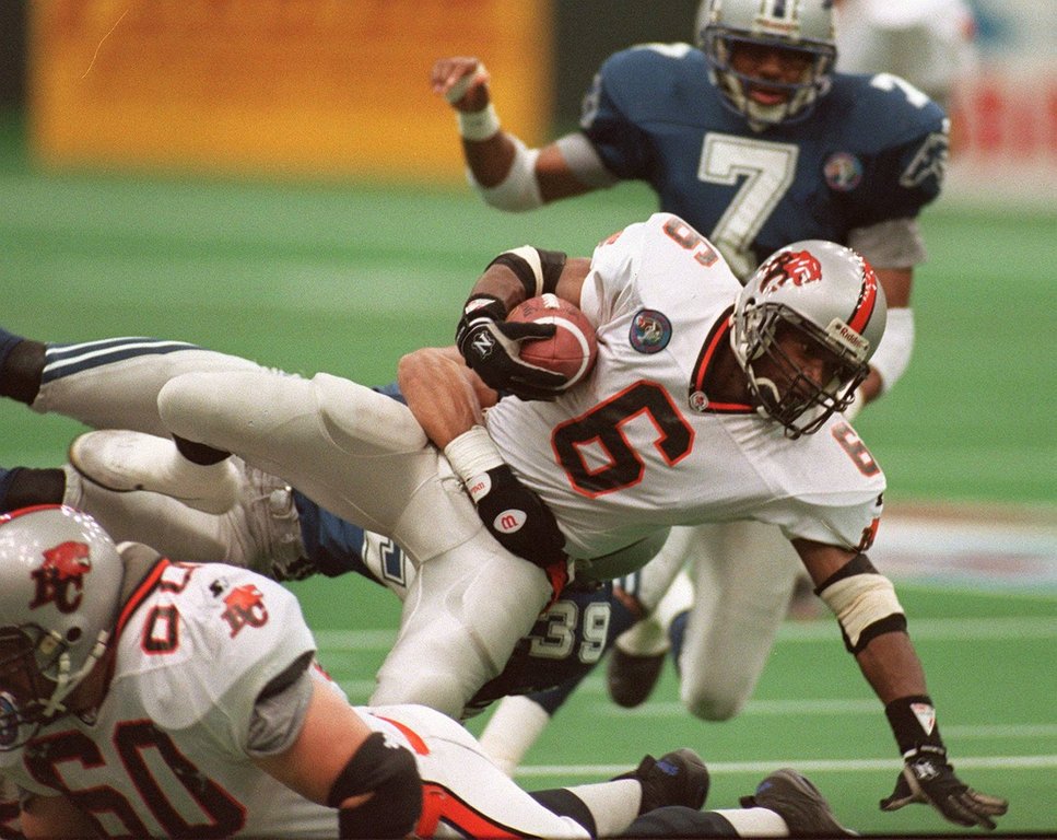 Grey Cup - BC Lions Cory Philpot is taken down by Baltimore 's Matt Goodwin. (Stf-Dave Buston).