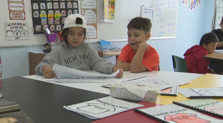 Sergeant Tommy Prince school students Genesis Wilson and Lincoln Ballantyne work on an Orange Shirt Day project.