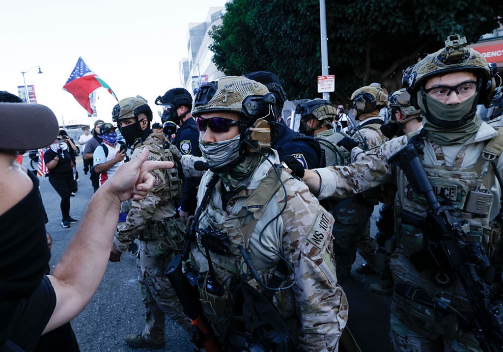 US Customs and Border Protection officers and DHS police push back Angelenos as they rally against the ongoing ICE raids taking place in the city in front of the Edward R. Roybal Federal Building on Friday, July 4, 2025 in Los Angeles, CA.