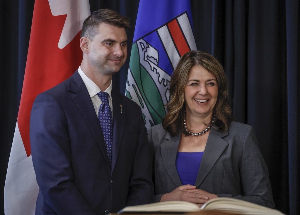 Alberta Premier Danielle Smith, right, stands with Minister of Municipal Affairs, Dan Williams, following a swearing in ceremony in Calgary, Friday, May 16, 2025.