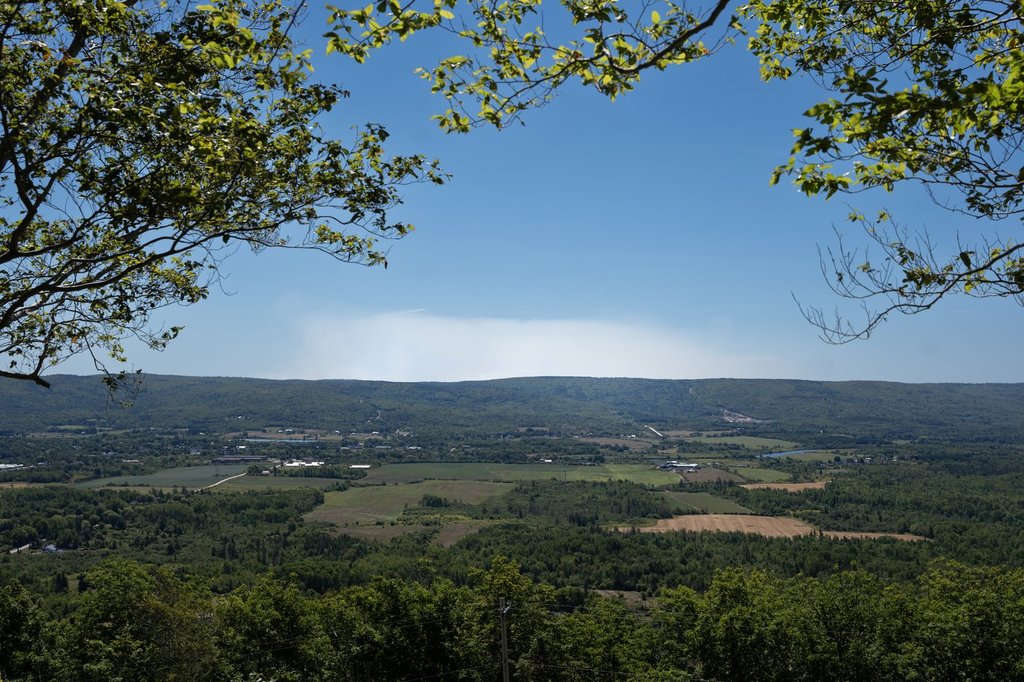 Smoke is seen over the landscape where firefighters are battling the Long Lake wildfire in Nova Scotia's Annapolis County, outside the community of West Dalhousie, N.S., on Tuesday, Aug. 19, 2025. THE CANADIAN PRESS/Darren Calabrese.