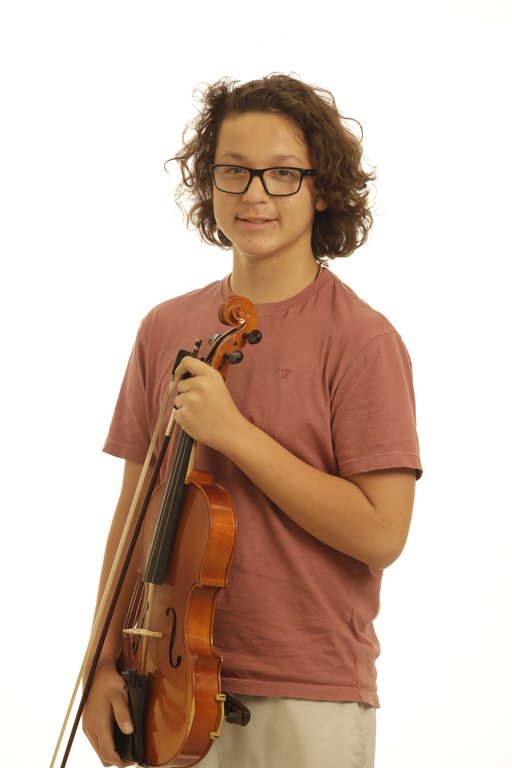 A young man poses in front of a white background