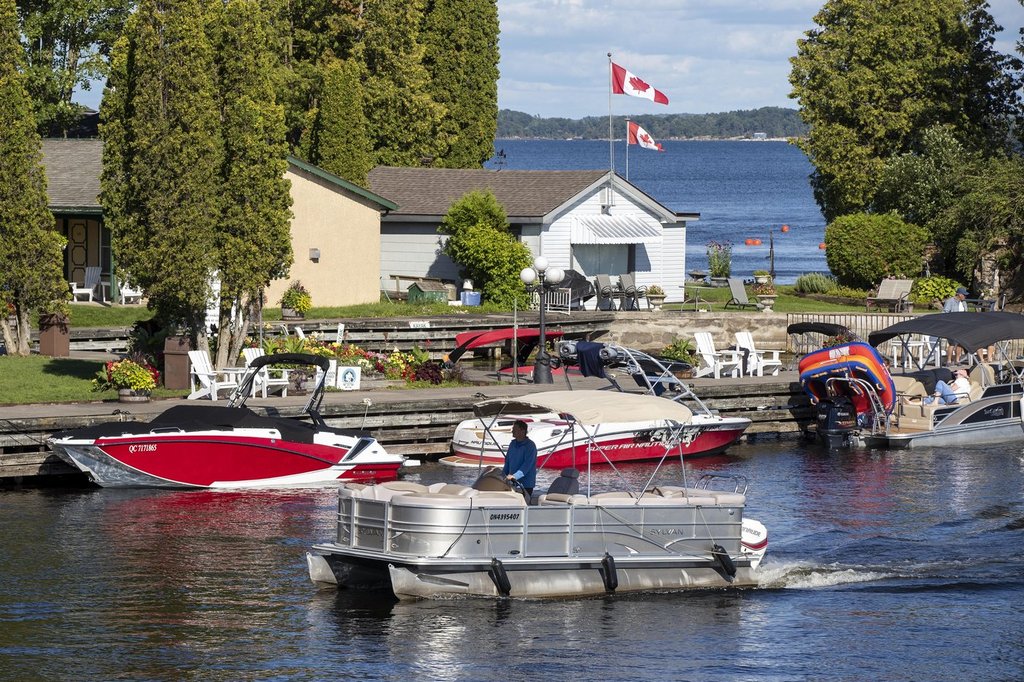 A person rides a boat in Lake Ontario in Gananoque, Ont., on Friday, July 30, 2021. 