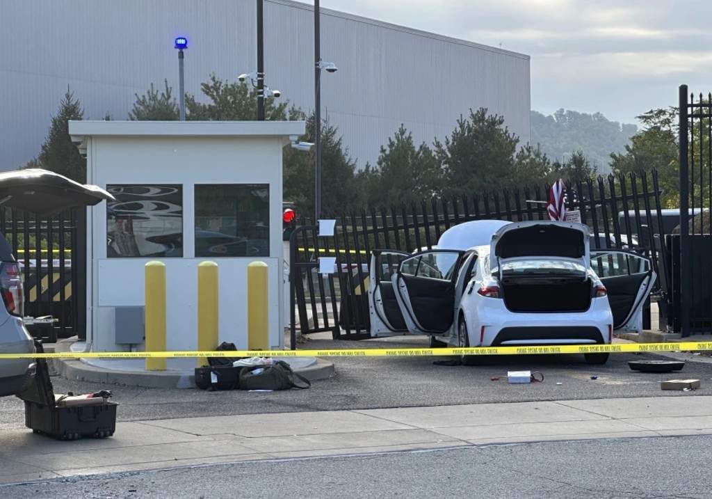FBI officials inspect a car that rammed into a gate at the FBI building in Pittsburgh, Wednesday, Sept. 17, 2025.