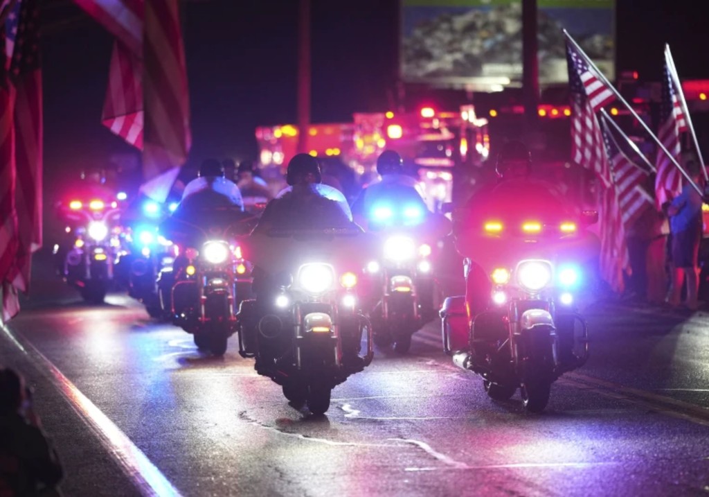 Police officers ride during a procession Wednesday, Sept. 17, 2025, in Spring Grove, Pa., after multiple police officers were shot and killed.