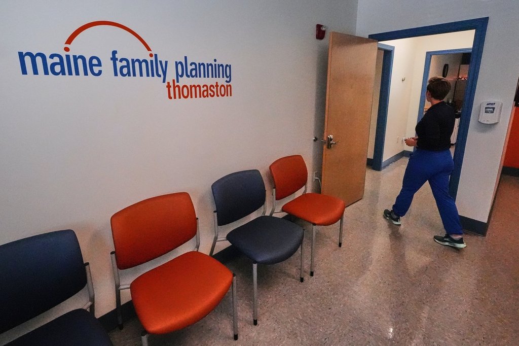 FILE - Vanessa Shields-Haas, a nurse practitioner, walks from the lobby toward the examination rooms at the Maine Family Planning healthcare facility, July 15, 2025, in Thomaston, Maine. (AP Photo/Charles Krupa, File).