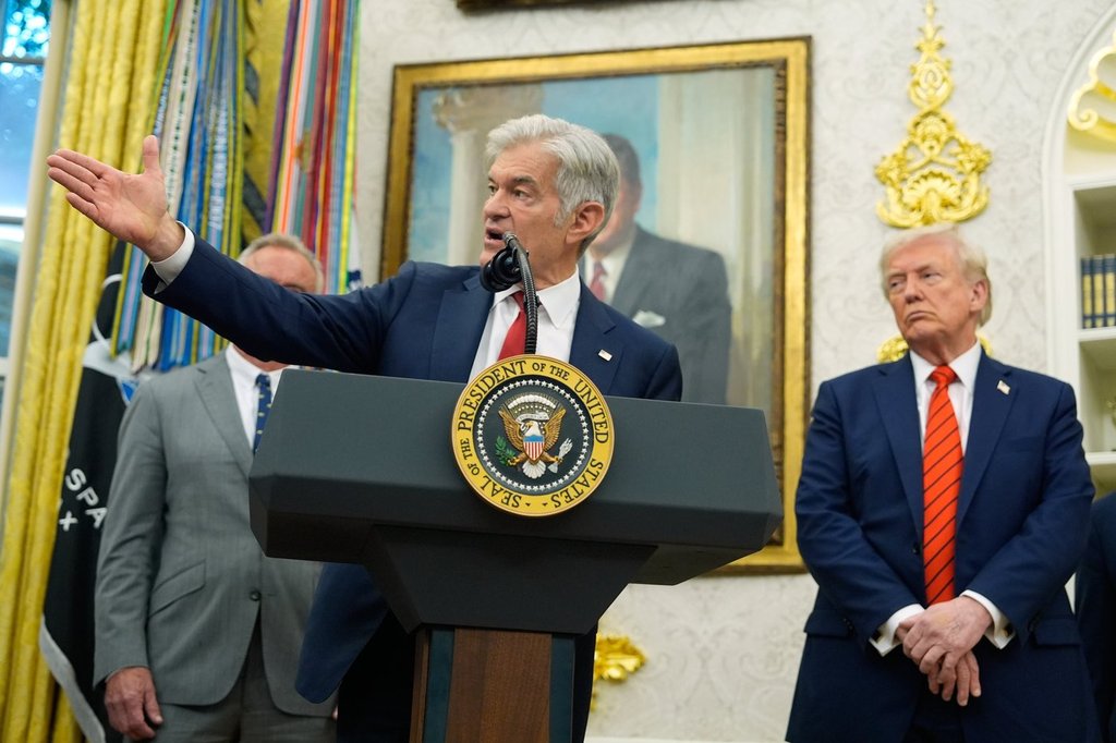 President Donald Trump listens as Centers for Medicare & Medicaid Services administrator Dr. Mehmet Oz speaks in the Oval Office of the White House, Friday, Oct. 10, 2025, in Washington. (AP Photo/Alex Brandon).