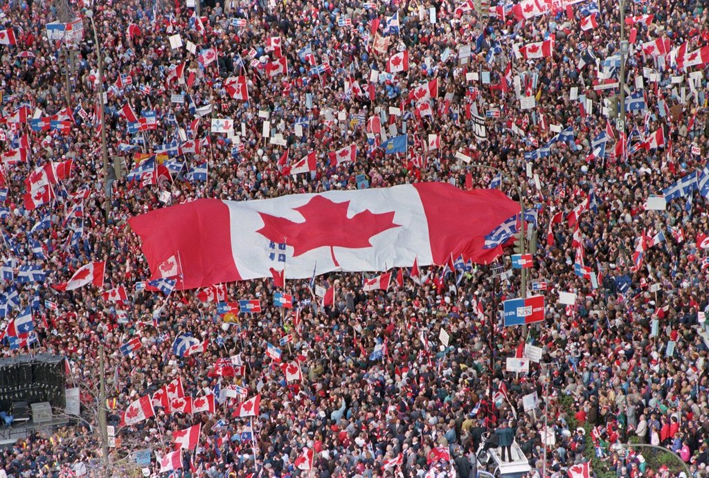 A large Canadian flag is passed through a crowd, as thousands streamed into Montreal from all over Canada on Friday, Oct. 27, 1995, to join Quebecers rallying for national unity, three days before the Oct. 30, 1995, Quebec sovereignty referendum.