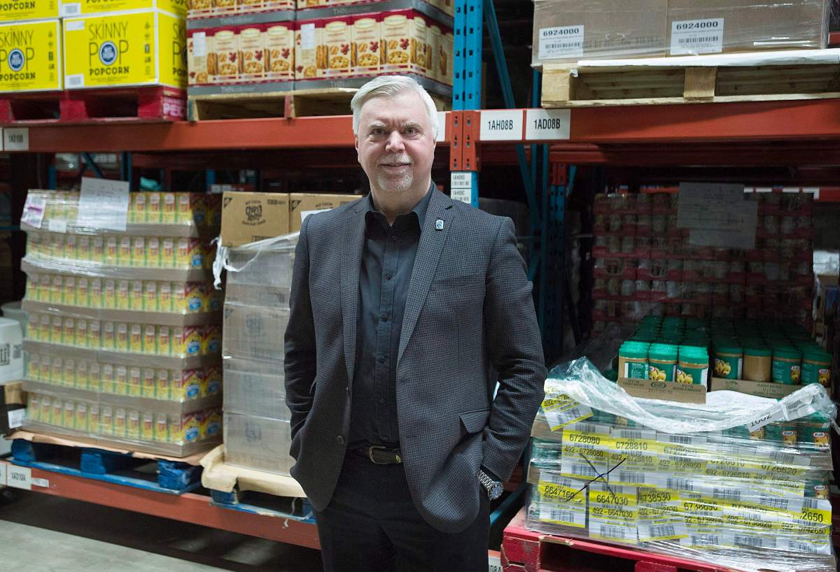 Welcome Hall Mission CEO Sam Watts poses next to pallets of food in the warehouse of the food bank in Montreal, Tuesday, March 14, 2017. 