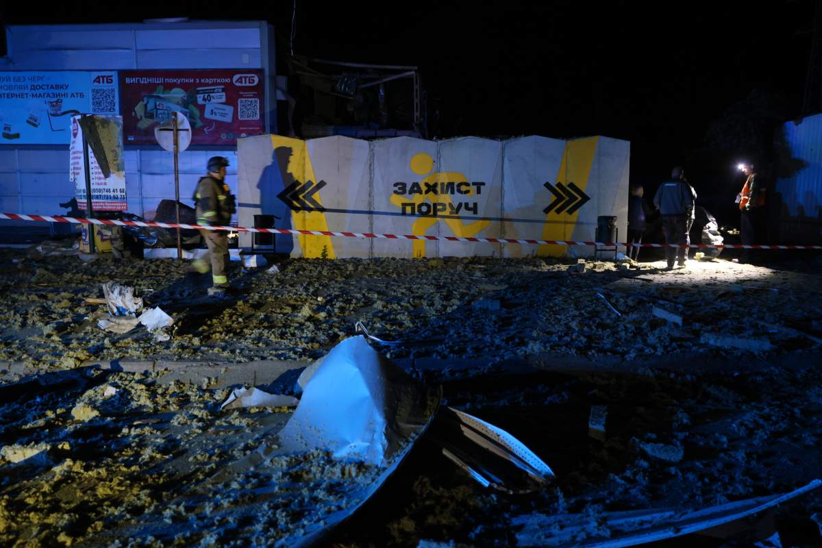 Rescuers work near a destroyed supermarket after a Russian drone strike in Zaporizhzhia, Ukraine, on Sept. 27, 2025.