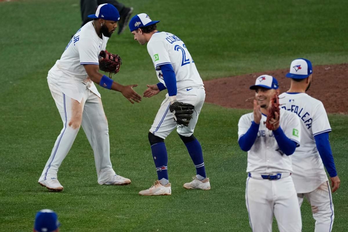 Toronto Blue Jays Vladimir Guerrero Jr., left, and Ernie Clement celebrate after Game 6 of baseball's American League Championship Series against the Seattle Mariners, Sunday, Oct. 19, 2025, in Toronto. 