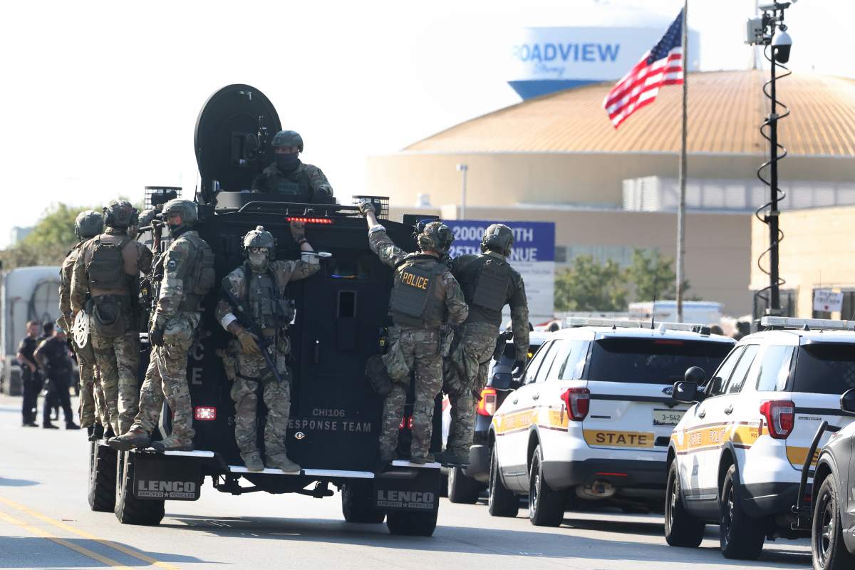 Federal agents on board an armor vehicle ride toward protesters as dozens of protesters clash with federal agents and Illinois State Police troopers near the U.S. Immigration and Customs Enforcement holding facility in Broadview, Illinois, on Oct. 3, 2025.