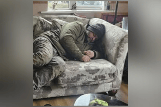 An AI generated image used to prank a person into believing an unhoused man was laying on their couch.