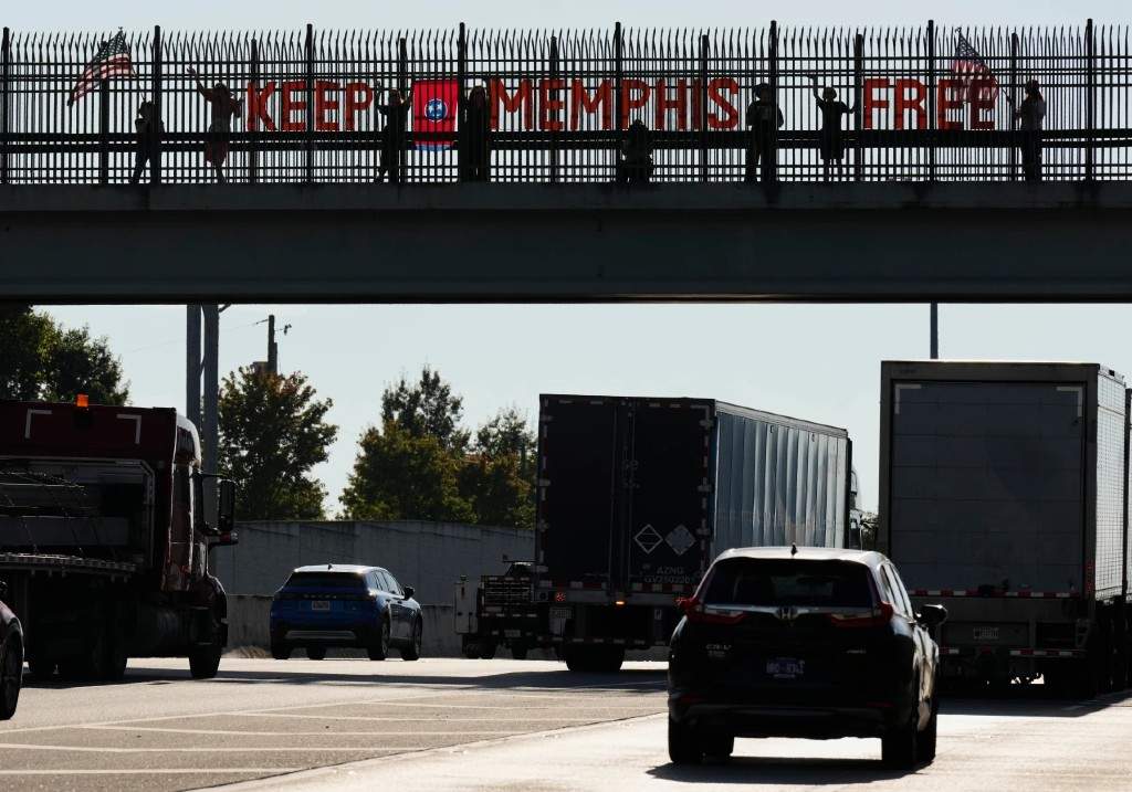 People demonstrate above Interstate 40 in Nashville, Tenn., Friday, Sept. 26, 2025, against the deployment of the National Guard in Memphis.
