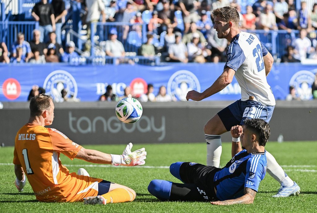 Nashville SC's goalkeeper Joe Willis (1) makes a save against CF Montreal's Ivan Jaime (11) as Nashville's Josh Bauer (22) defends during first half MLS soccer action in Montreal, Saturday, Oct. 4, 2025. THE CANADIAN PRESS/Graham Hughes.