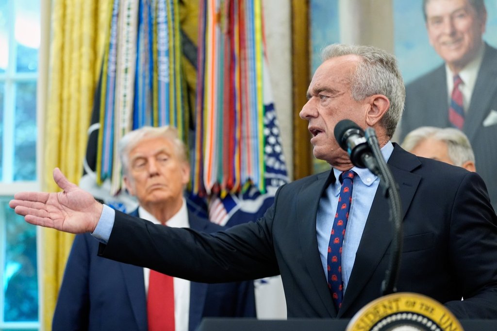 FILE - Secretary of Health and Human Services Robert F. Kennedy Jr. speaks in the Oval Office of the White House, Tuesday, Sept. 30, 2025, in Washington, as President Donald Trump looks on. (AP Photo/Alex Brandon, File) (AP Photo/Alex Brandon, File).