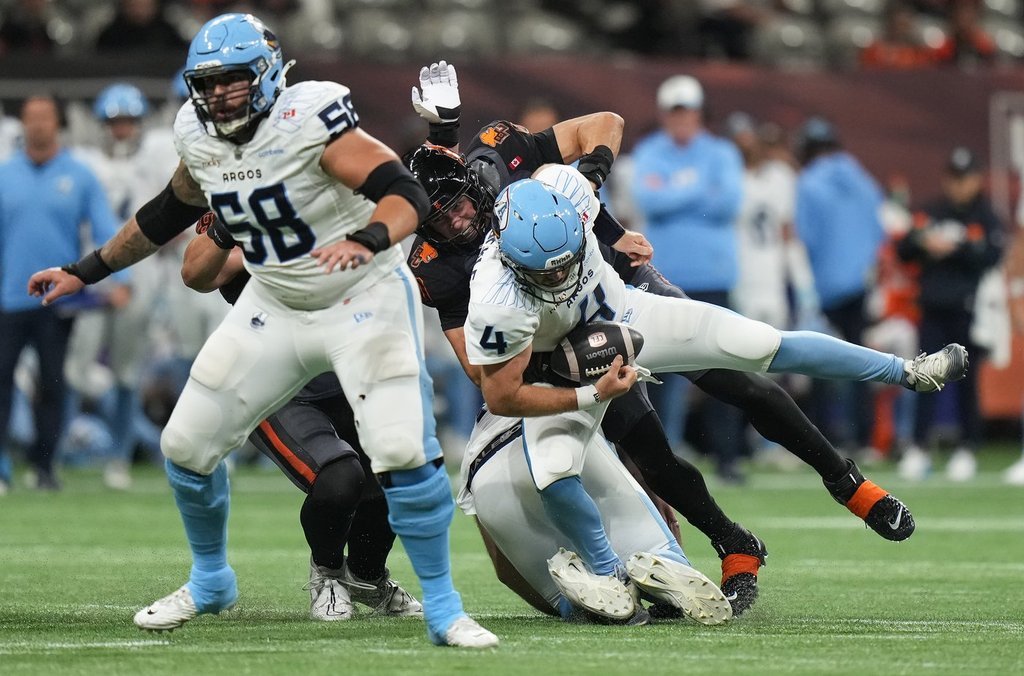 B.C. Lions' Mathieu Betts, back centre, sacks Toronto Argonauts quarterback Nick Arbuckle (4) behind Anthony Vandal (58) during the first half of a CFL football game, in Vancouver, on Friday, September 26, 2025. THE CANADIAN PRESS/Darryl Dyck.