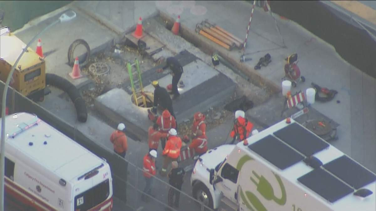 An aerial view of the "industrial incident" on Macleod Trail in Calgary Thursday morning, shows emergency responders surrounding a manhole in the roadway.
