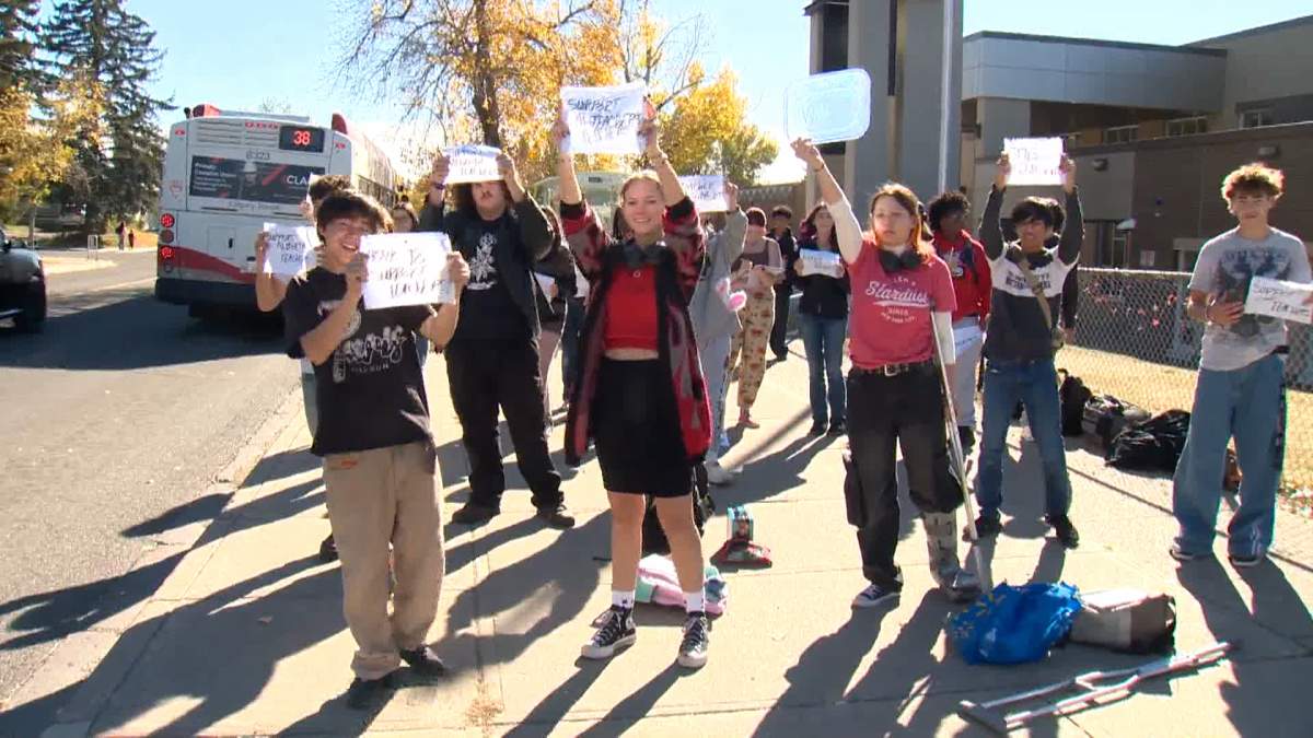 A group of students gather on a sidewalk outside St. Francis High School in northwest Calgary, calling for more funding for education in the province, and expressing their concerns over the long term impact a teachers strike could have on their education.