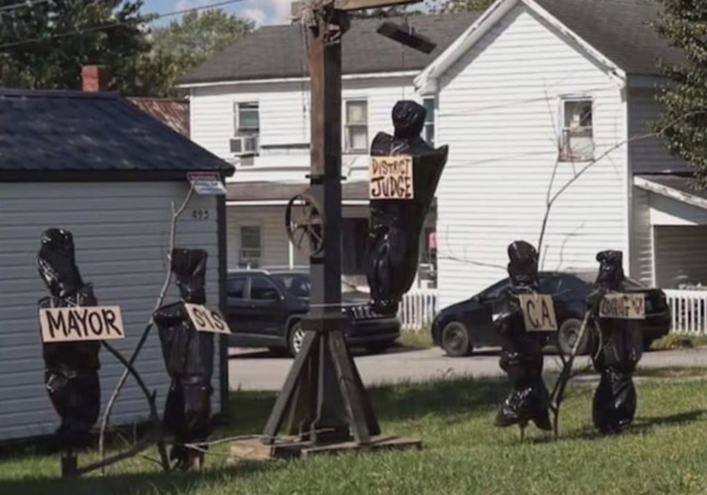 A Kentucky man was arrested after authorities found his Halloween display allegedly depicting bodies of local officials.