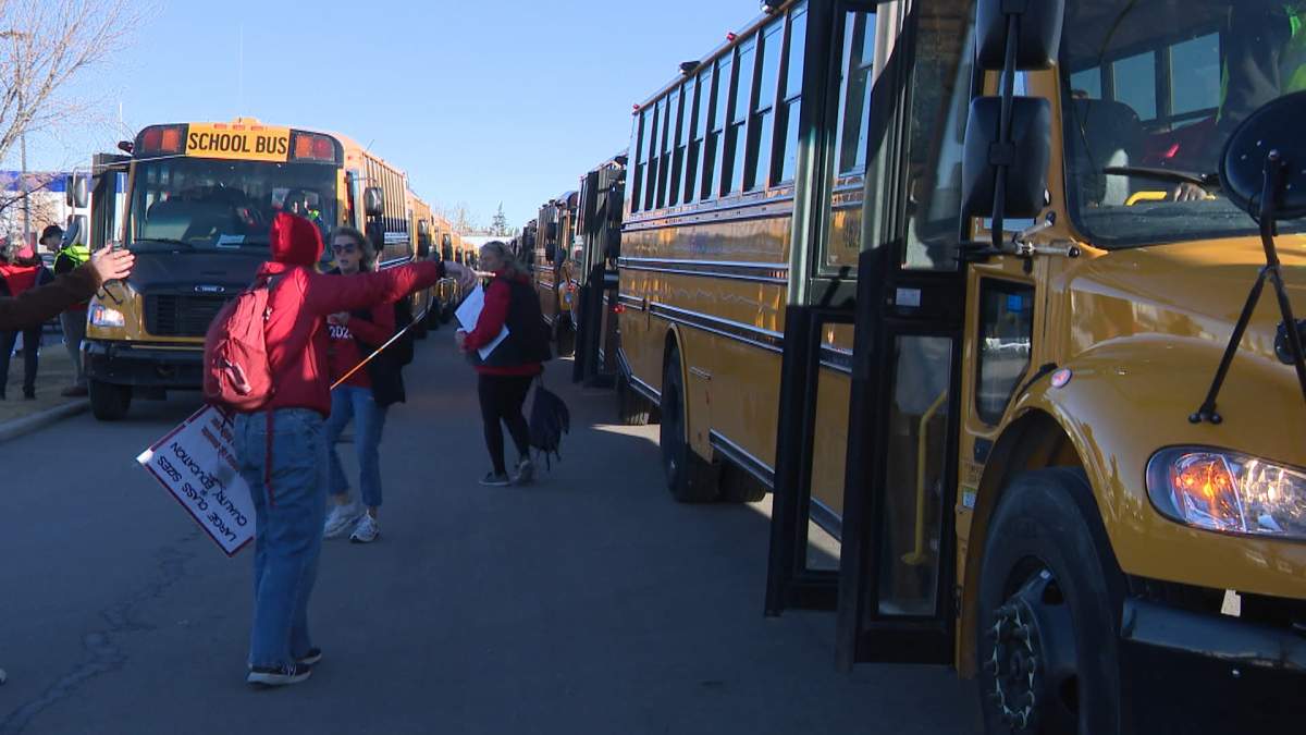 Busloads of teachers are seen in a Calgary parking lot as they prepare for the trip to Edmonton to join a rally by thousands of teachers outside the Alberta legislature on Thursday afternoon.