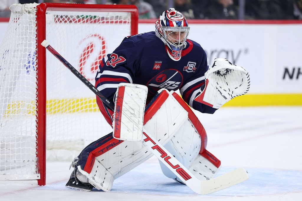Winnipeg Jets goaltender Connor Hellebuyck (37) defends his net against the Minnesota Wild during the first period of an NHL hockey game Tuesday, Oct. 28, 2025, in St. Paul, Minn. (AP Photo/Matt Krohn).