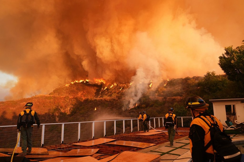 FILE - Fire crews monitor the Palisades Fire in Mandeville Canyon on Jan. 11, 2025, in Los Angeles. (AP Photo/Jae C. Hong, File).