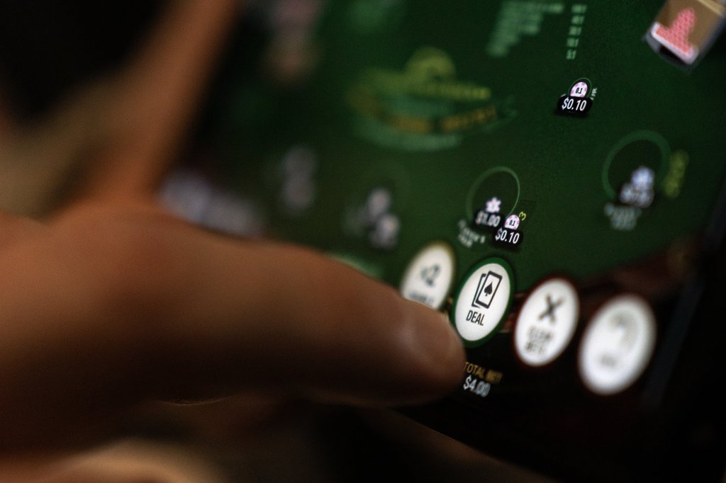 A "deal" button on a casino app in shown on a smartphone in a photo illustration made in Toronto, Wednesday, Jan. 17, 2024. ni.
