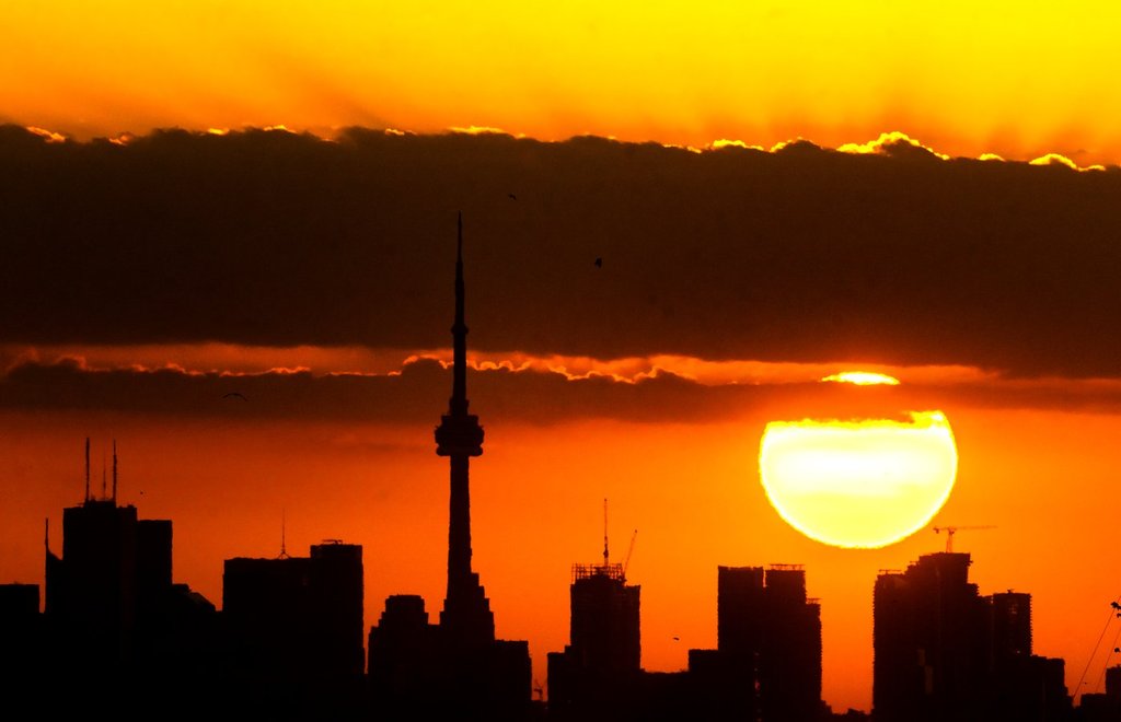 The sun rises over the Toronto skyline, Tuesday, June 24, 2025. THE CANADIAN PRESS/Frank Gunn.