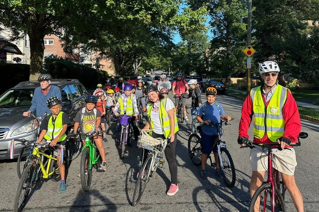 From a few to more than 350, children and parents ride together to school as a ‘bike bus’