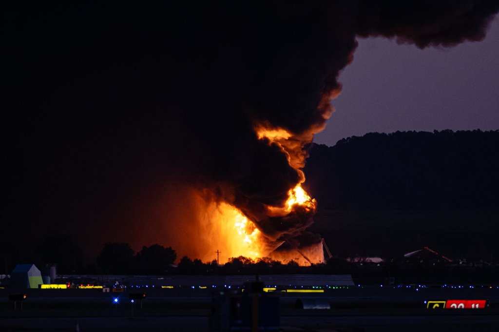 A fireball erupts near airport property after reports of a plane crash at Louisville International Airport, Tuesday, Nov. 4, 2025, in Louisville, Ky. (AP Photo/Jon Cherry).