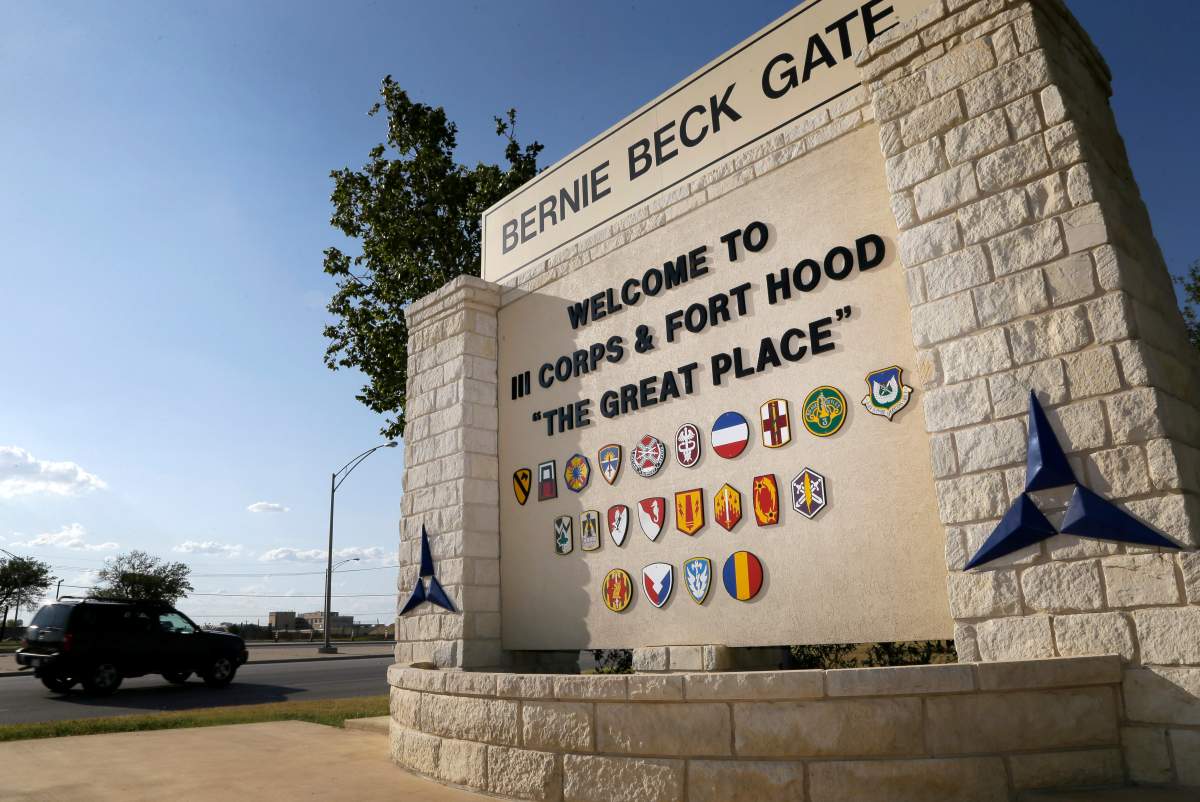 FILE - In this July 9, 2013, file photo, traffic flows through the main gate past a welcome sign in Fort Hood, Texas. U.S.