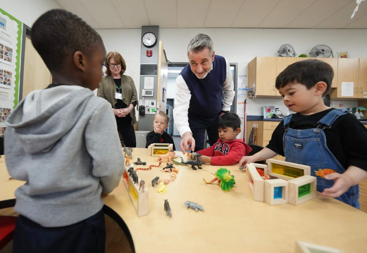 Ontario Minister of Education Paul Calandra, centre, visits children at the Blessed Chiara Badano Child Care Centre in Stouffville, Ont., Friday, May 2, 2025. 