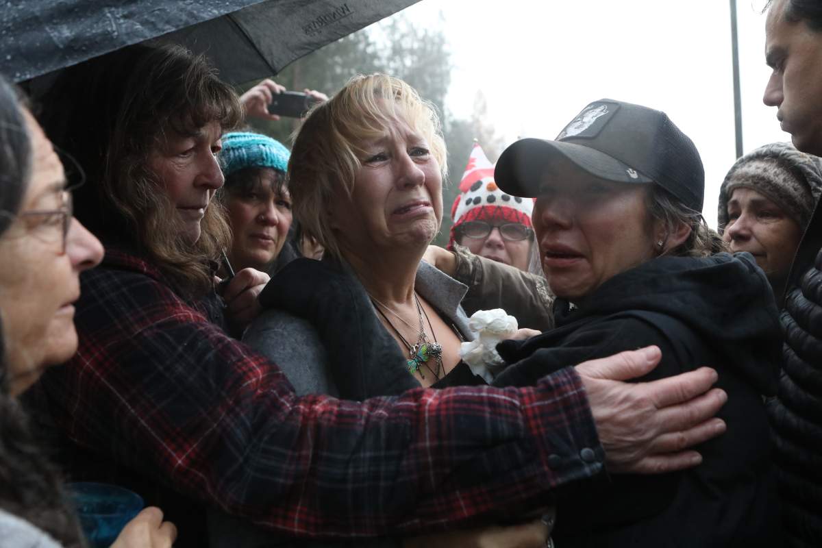 Karen Espersen, the co-owner of Universal Ostrich Farms, is embraced by supporters and her daughter, Katie Pasitney, at the farm in Edgewood, B.C., after the Supreme Court of Canada declined to hear the farm’s appeal against an order to cull more than 300 of its ostriches on Thursday, Nov. 6, 2025.