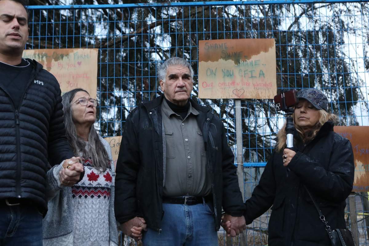 Dave Bilinski, the co-owner of Universal Ostrich Farms, participates in a group prayer in Edgewood, B.C., on Thursday, Nov. 6, 2025.