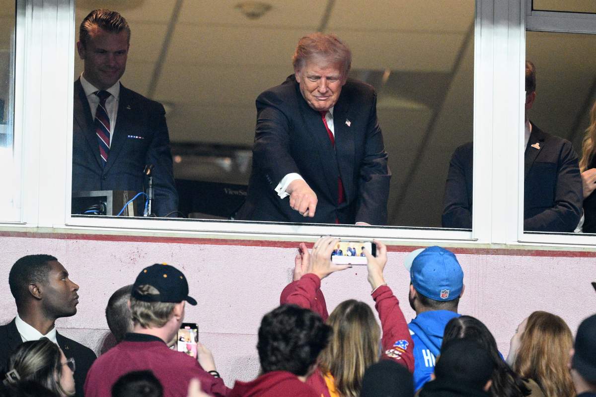 President Donald Trump is seen in a suite alongside Defense Secretary Pete Hegseth, left, during halftime of an NFL football game between the Washington Commanders and the Detroit Lions Sunday, Nov. 9, 2025, in Landover, Md.