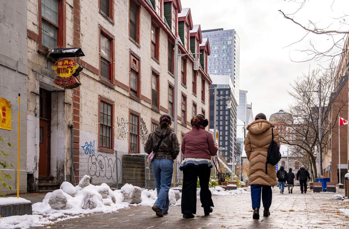 People walk past Wing Noodles Ltd. in Montreal’s Chinatown on Monday, Nov. 17, 2025. The family run business began producing Chinese noodles, egg roll and wonton covers in 1946, to become Quebec’s largest Asian noodle and cookie manufacturer, has announced it will be closing at the end of November.