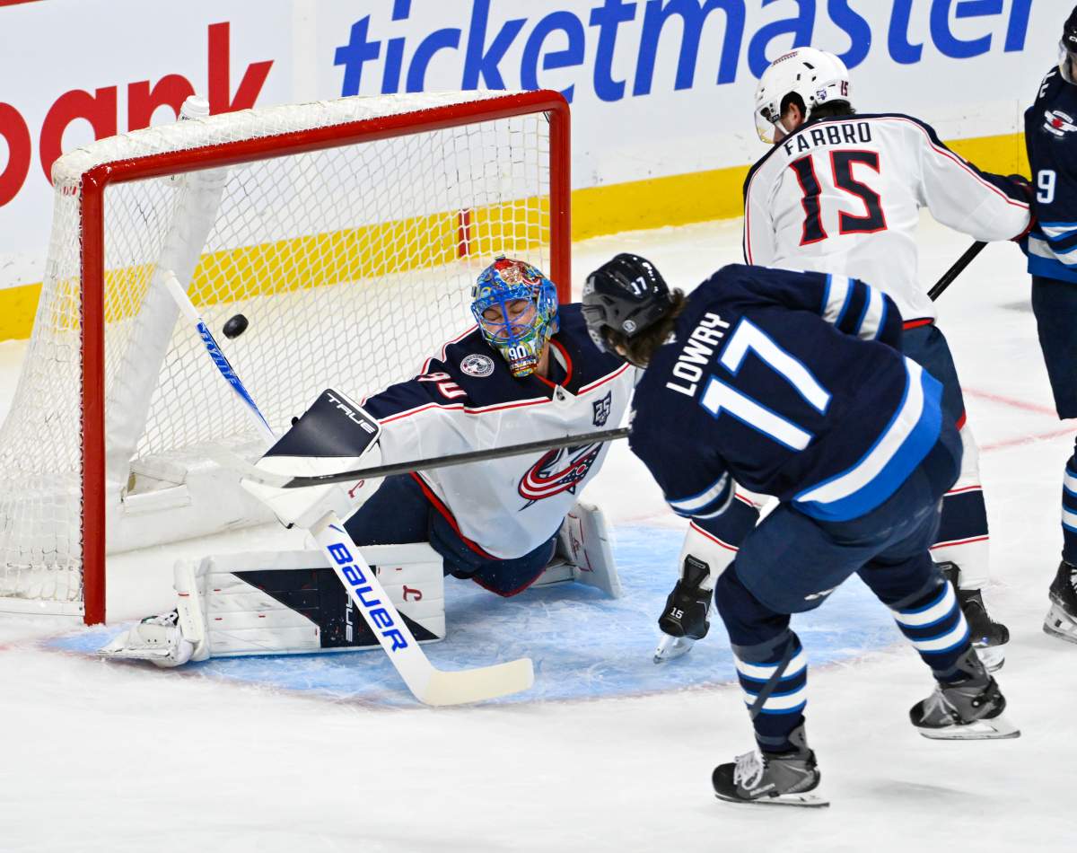 Winnipeg Jets' Adam Lowry (17) scores on Columbus Blue Jackets goaltender Elvis Merzlikins (90) during the first period of their NHL hockey game in Winnipeg, Tuesday November 18, 2025. THE CANADIAN PRESS/Fred Greenslade.