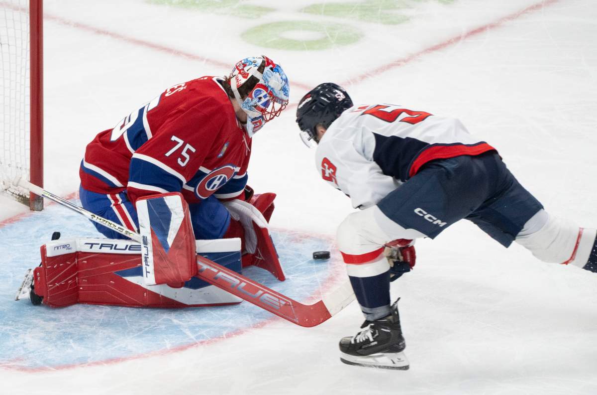 Montreal Canadiens goaltender Jakub Dobes (75) makes a save against Washington Capitals' Ethen Frank (53) during second period NHL hockey action in Montreal on Thursday, Nov. 20, 2025. 