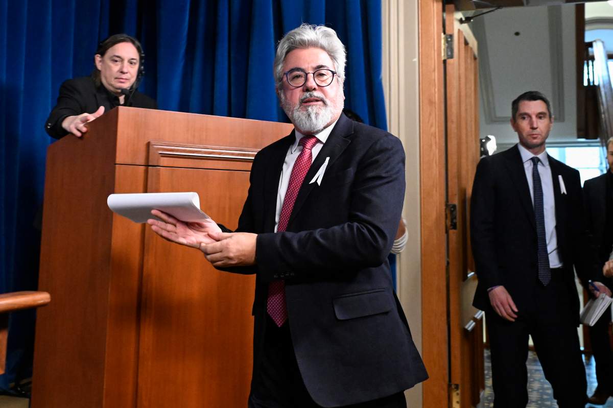 Quebec Liberal Leader Pablo Rodriguez walks in a news conference at the legislature in Quebec City, Tuesday, Nov. 25, 2025. Opposition Leader André Fortin, right, walks along.